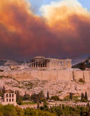 View of the Acropolis and the Parthenon against the background of smoke from fires in Athens