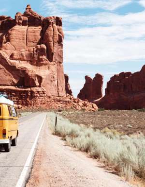 Yellow Volkswagen bus driving through Utah