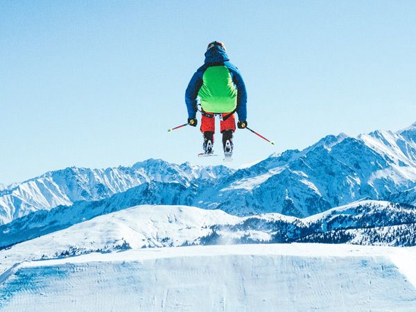 skiing in the air in the snowy mountains