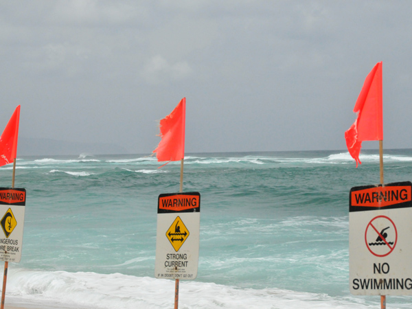 no swimming warning sign at the beach
