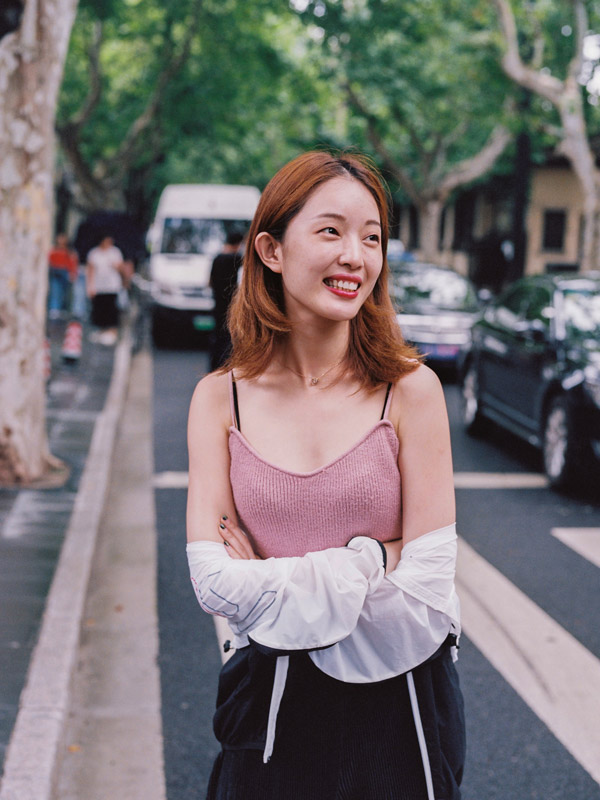 a smiling woman in the street at Shanghai, China