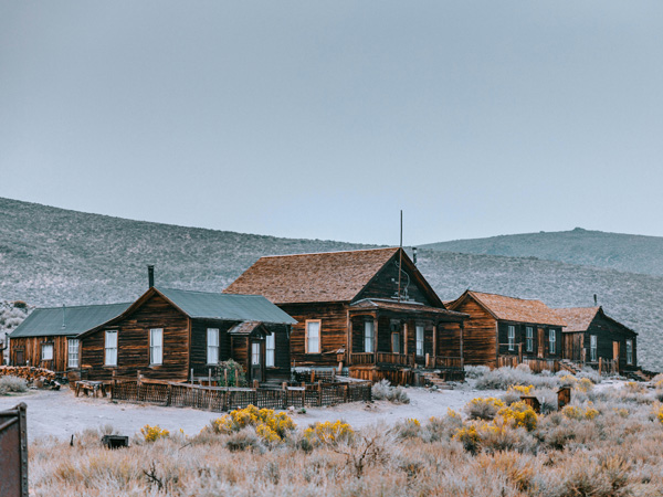 a wooden house in the middle of a field in Bodie, California, USA