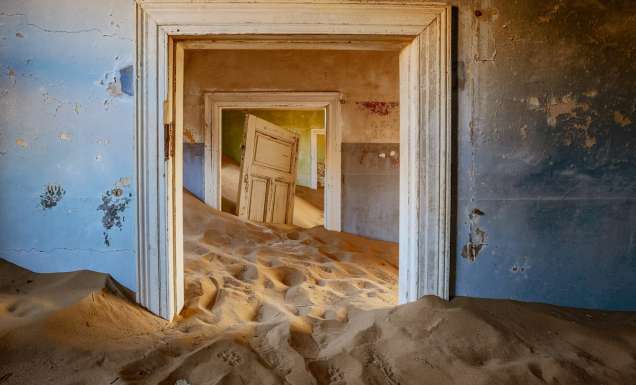 sand dunes covering the floor of an old house in Kolmanskop, Namibia