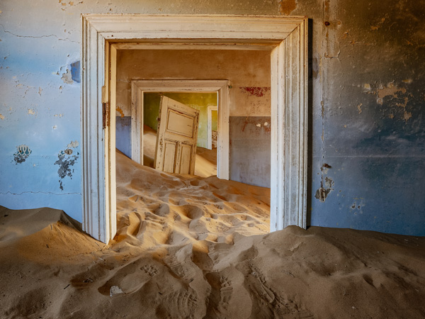 sand dunes covering the floor of an old house in in Kolmanskop, Namibia