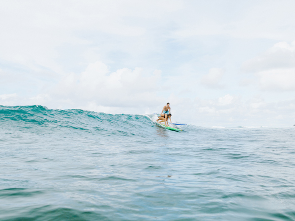 surfers riding big waves in North Shore, Oahu