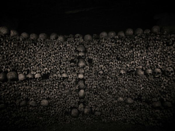 inside the Paris Catacombs full of skulss