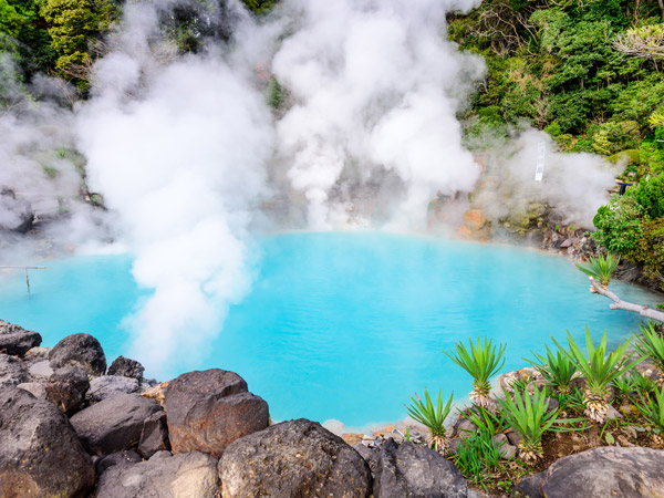 a pool of milky blue water shrouded in steam, Sea Hell Hot Spring