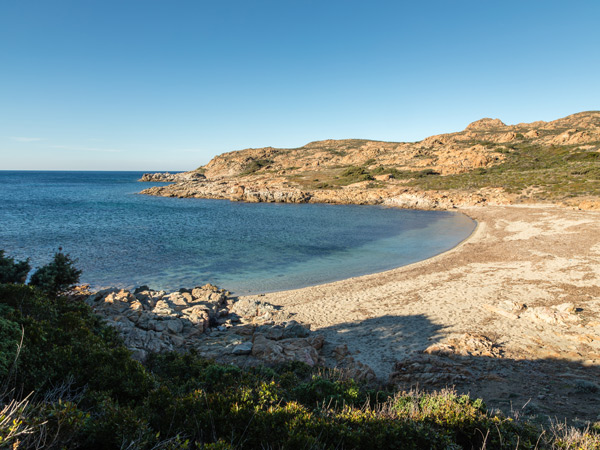 a clear blue sea and deserted beach on the coastline of the Desert des Agriates