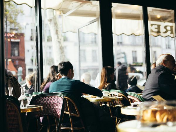 people dining inside Cafe de Flore in Paris