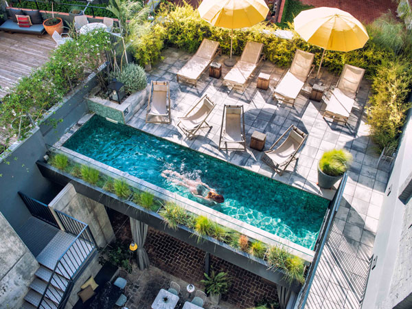 an overhead shot of a person swimming in the pool at Hotel Brummell, Barcelona