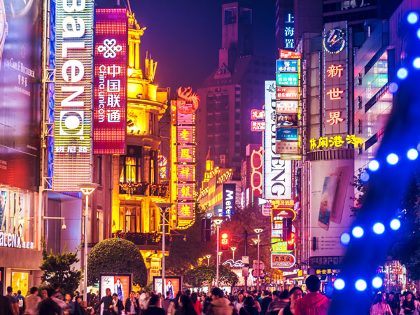 a busy shopping district with Neon signs on Nanjing Road