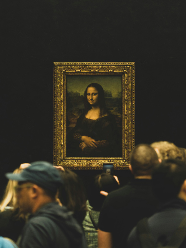 museum visitors looking at Mona Lisa painting