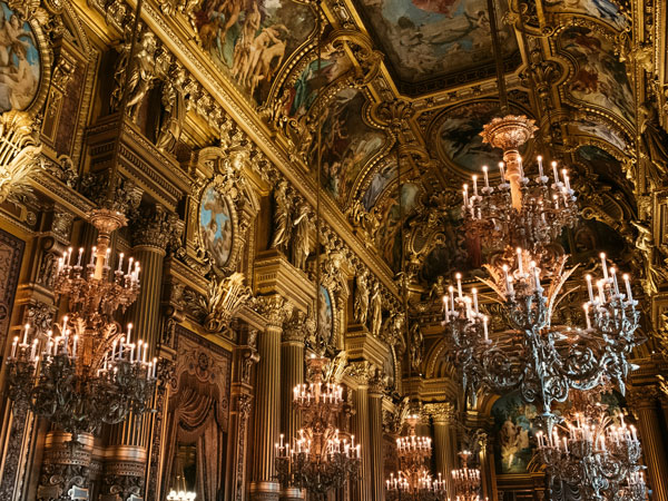 elegant and elaborate ceiling with chandeliers inside Palais Garnier