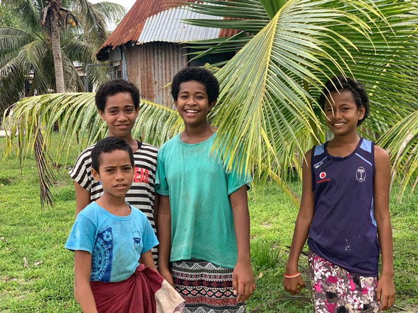 children posing for a photo in a remote village in Fiji