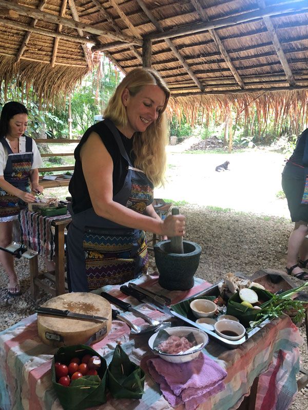 visitors participating in a Thai cooking class
