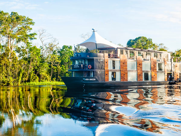 the Uniworld Aria Amazon cruising through the Amazon river