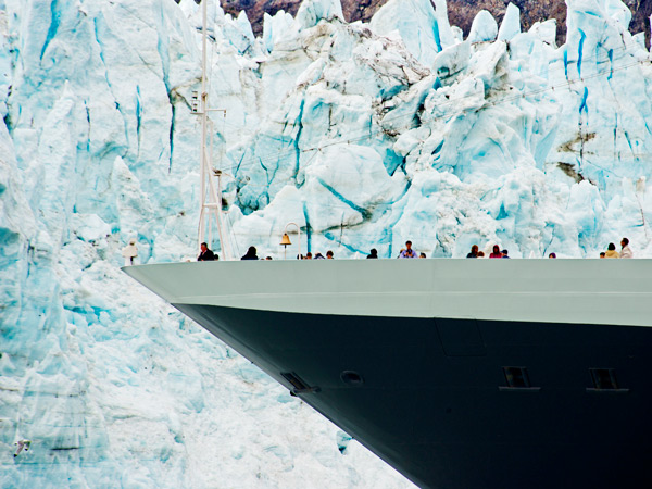 a ship getting close to towering glaciers
