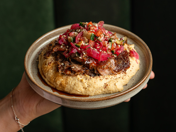 a plate of hummus shawarma, The Refuge, Manchester