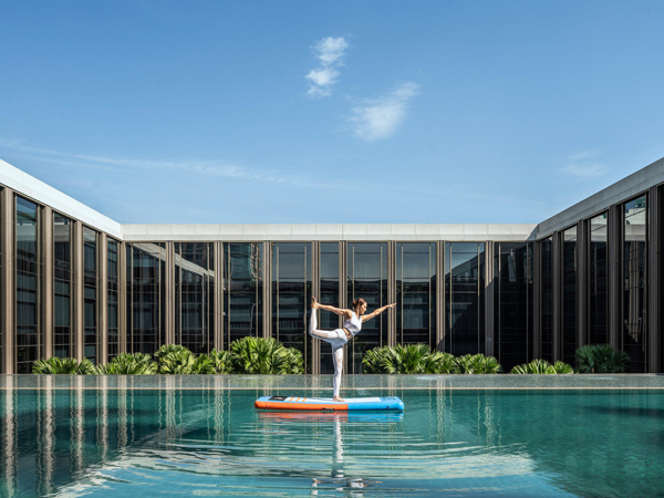 a woman doing yoga at the pool, Four Seasons Bangkok