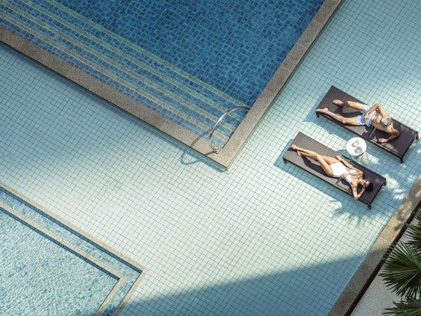 Woman and man in pool at Four Seasons Bangkok