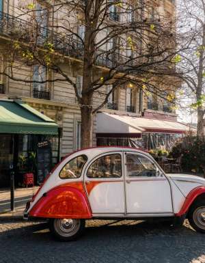 french vintage car on street in front of restaurants at ile-de-france in paris