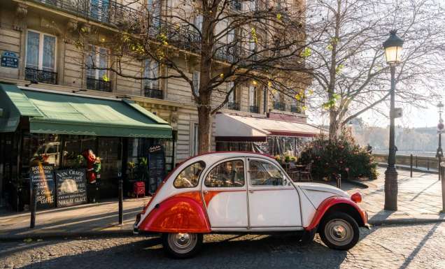 french vintage car on street in front of restaurants at ile-de-france in paris