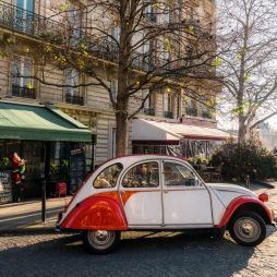 french vintage car on street in front of restaurants at ile-de-france in paris