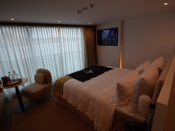 the bed facing the curtains at the Panorama Suite, Avalon Alegria