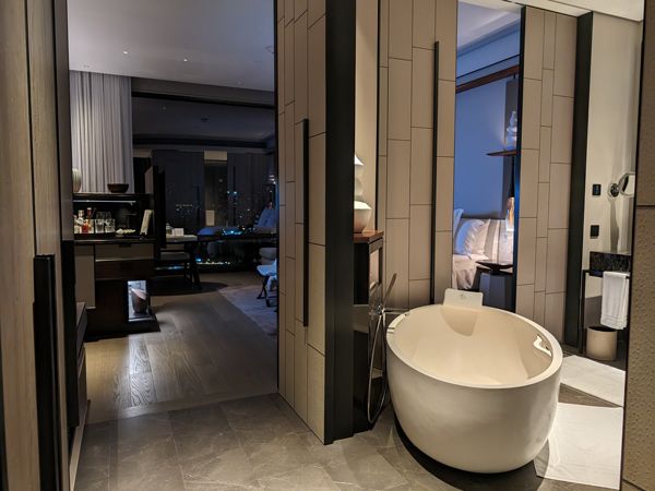 the bathroom with a separate tub and rain shower at the Deluxe River View, Four Seasons Bangkok