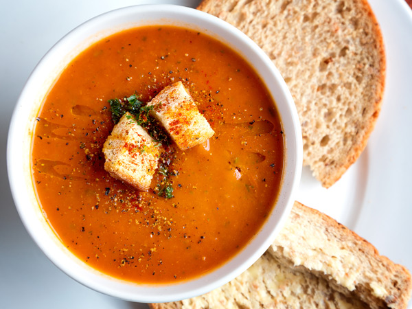 a fresh tomato soup in white ceramic bowl