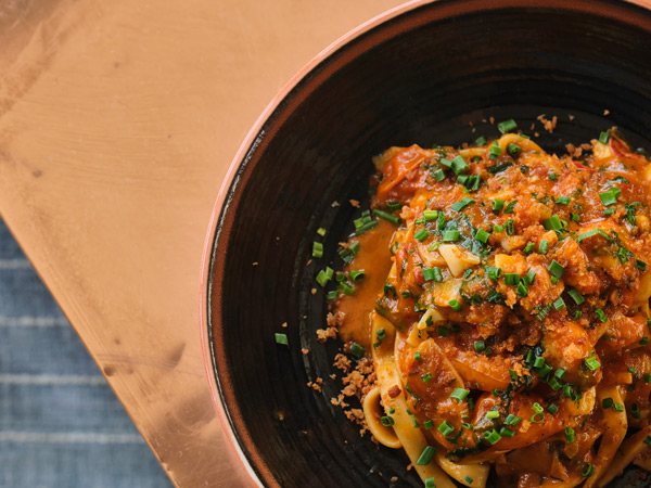 a close-up shot of Maine lobster arrabbiata dish at Buccan