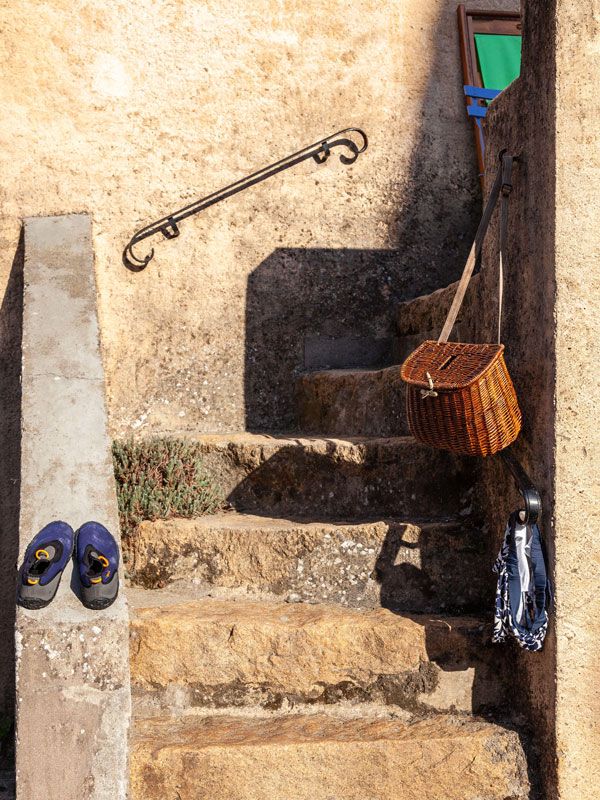 a swimsuit dries on the steps of a local home in Piana town