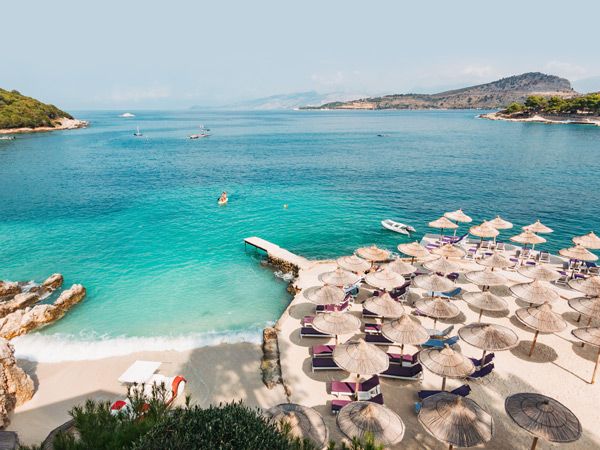 an aerial view of beach umbrellas clustered at Ksamil