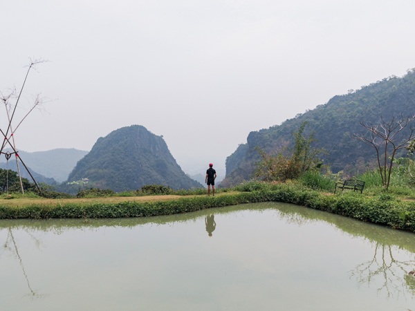 a man standing at the top of Chiang Rai-Suan Khun Pu Life Museum Cafe
