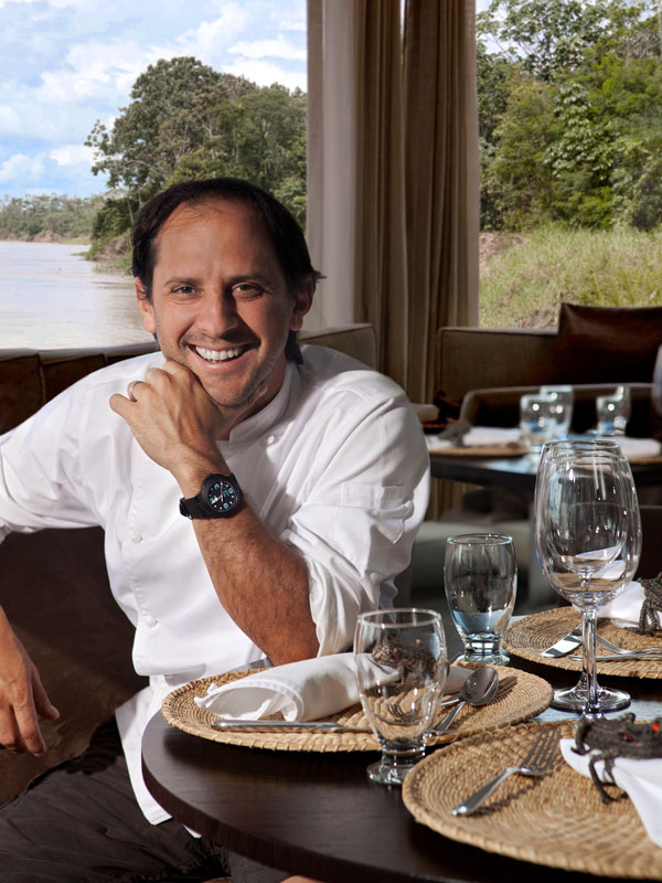 Chef Pedro Miguel sitting at a dining table onboard Aqua Nera