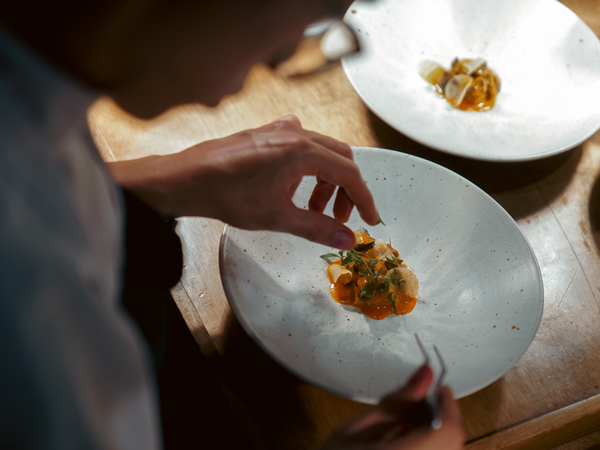 a chef plating food at El Chato