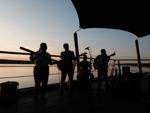 the Chunky Monkey Band performing onboard Aqua Nera at sunset