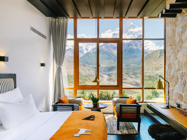floor-to-ceiling windows frame views of the snow-capped Nilgiri Himal peaks at Shinta Mani Mustang