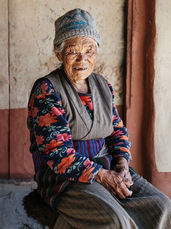 a portrait of an old woman at the community near Shinta Mani Mustang
