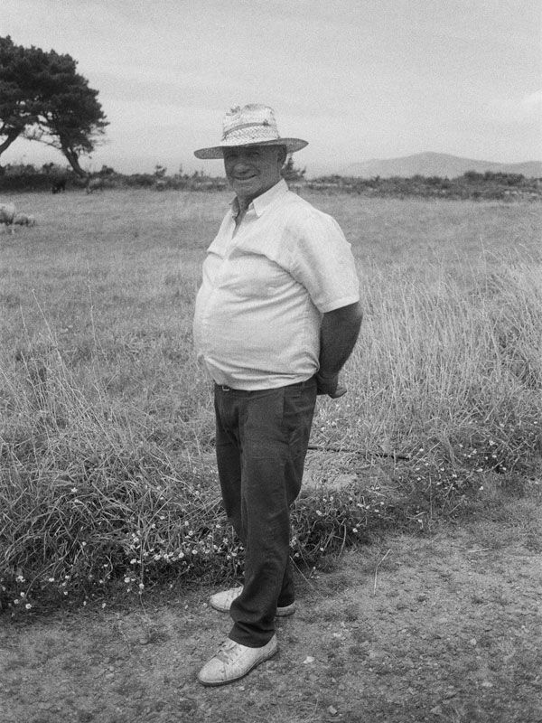 a black and white photo of a farmer