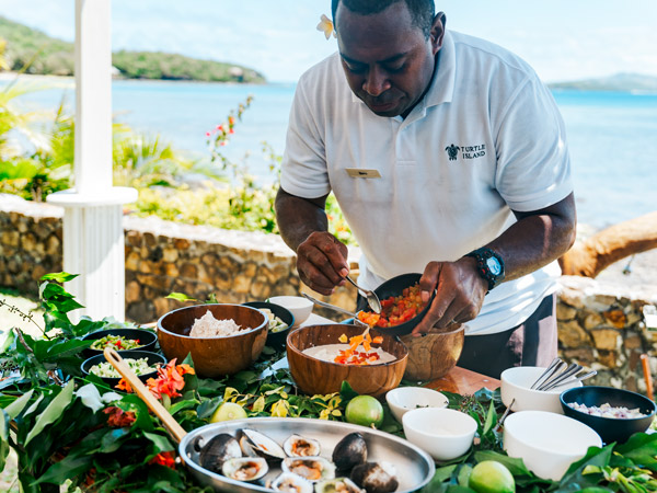 Chef Beni prepares lunch for guests on Turtle Island