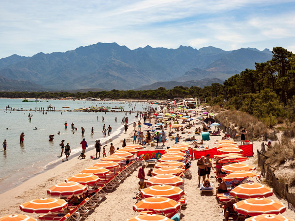 colourful parasols on a beach in Calvi
