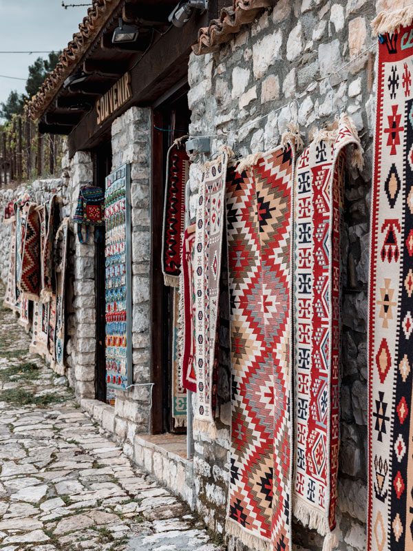 colourful ottoman style rugs outside a souvenir shop in Berat, Albania