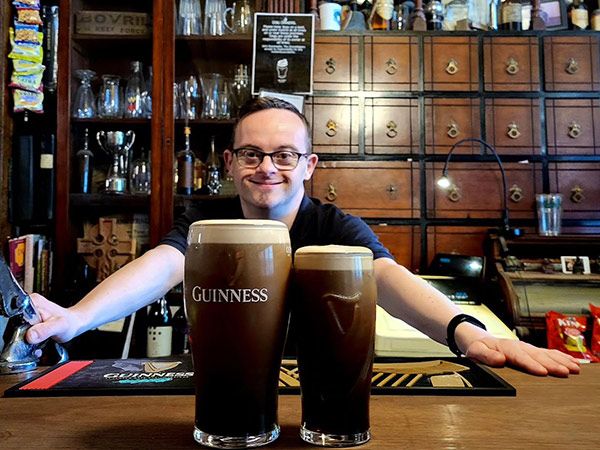 manager pouring guiness at John Kavanagh The Gravediggers