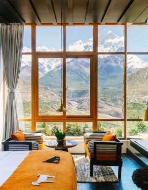 floor-to-ceiling windows frame views of the snow-capped Nilgiri Himal peaks at Shinta Mani Mustang