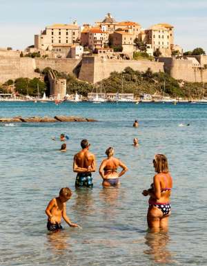 bathers cooling off at Calvi’s 13th-century citadel