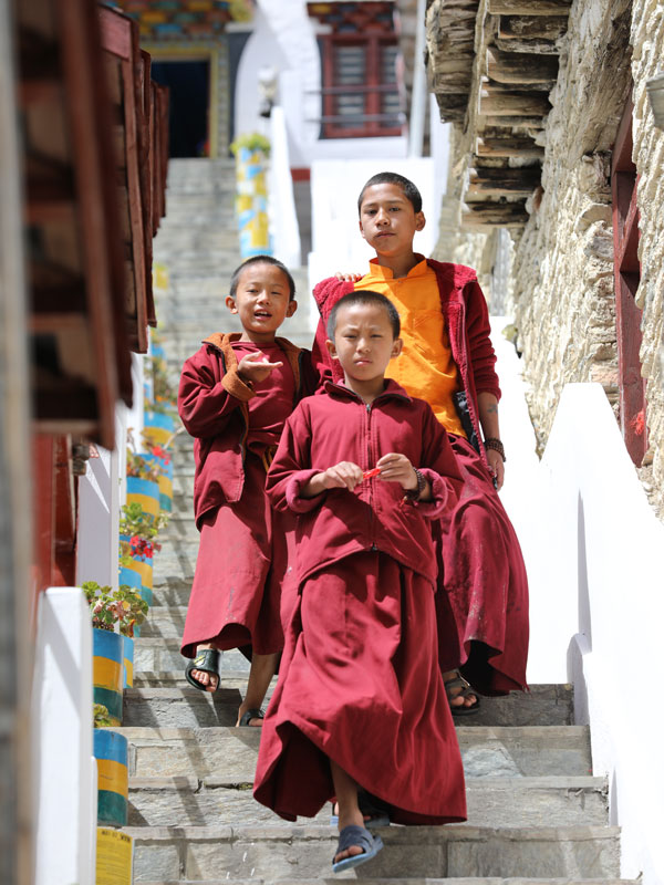 monks walking down the stairs in Marpha Mustang village, Nepal