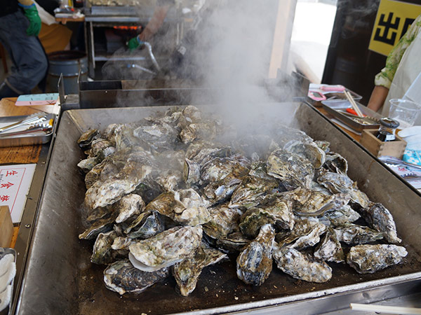 people eating oysters in a restaurant in Miyagi Prefecture japan