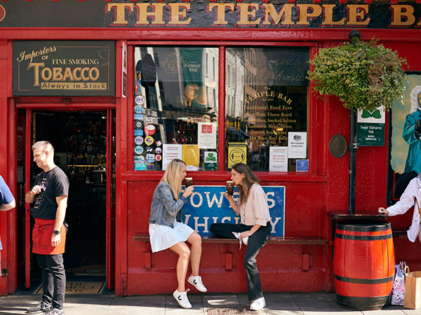 two women sitting outside Temple Bar Dublin Pubs