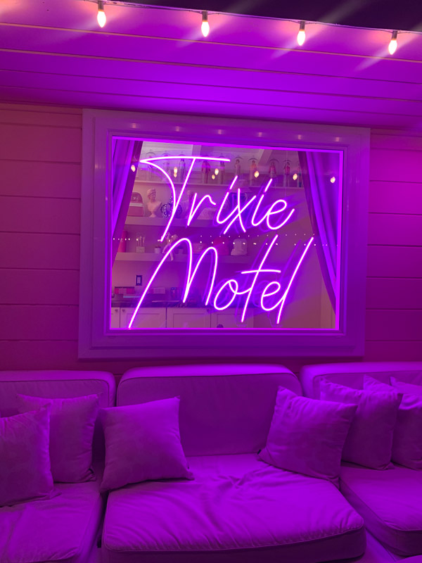 the vibrant deep pink-lit Trixie Motel at night